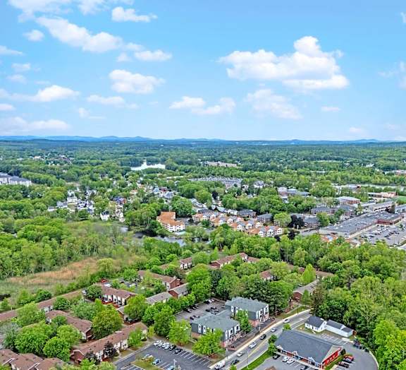A small town with a lot of greenery and a few buildings.