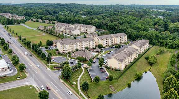 an aerial view of an apartment complex next to a river