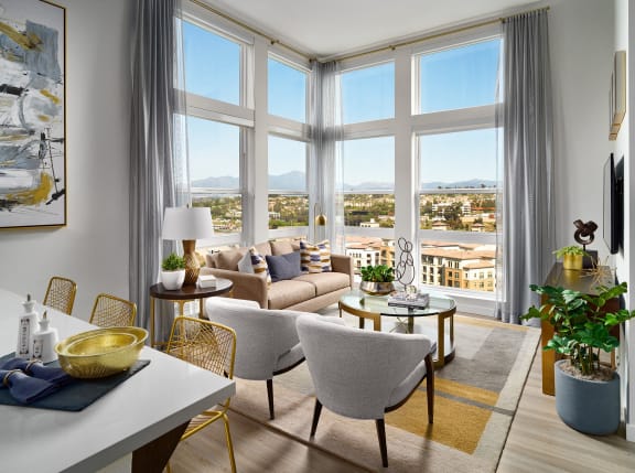 a living room with large windows and a view of a city