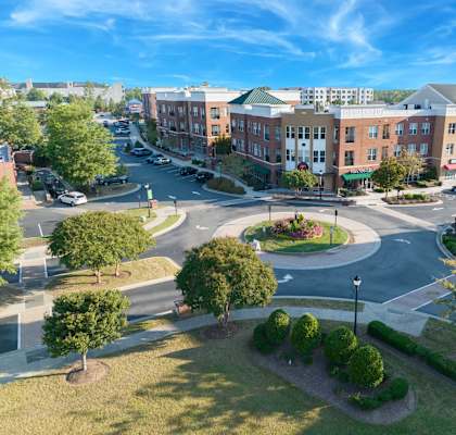 A roundabout in a city with buildings around it.