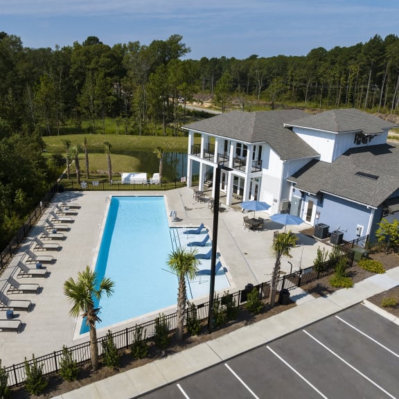 an aerial view of a swimming pool and a building with a resort style pool