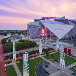 a view of the mercedes benz stadium at sunset