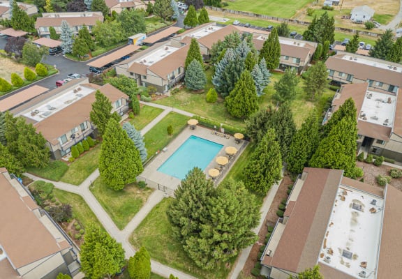 an aerial view of a community with a pool and trees at Cedarwood, Wenatchee, WA