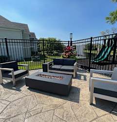 A set of outdoor furniture is arranged on a patio.