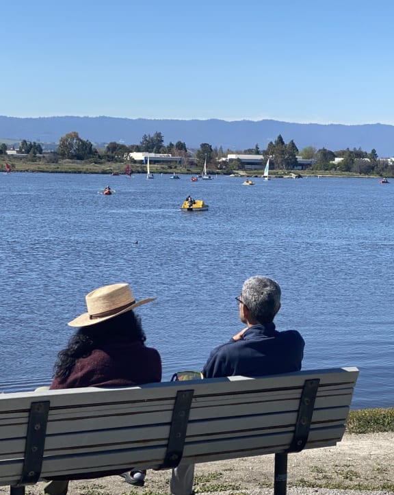 people sitting on a bench in a park