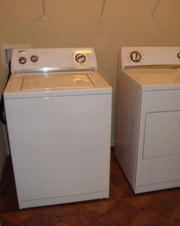 the laundry room has two washers and a dryer