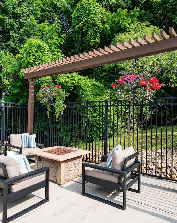 an outdoor kitchen with stainless steel appliances and bar stools