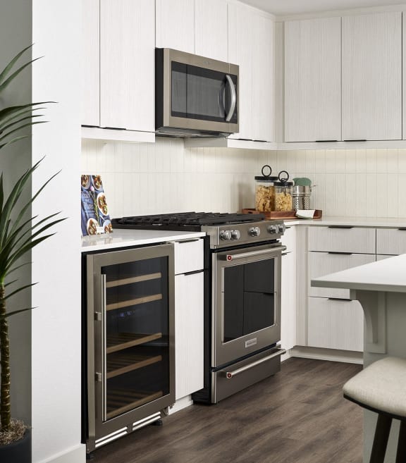 a kitchen with stainless steel appliances and white cabinets