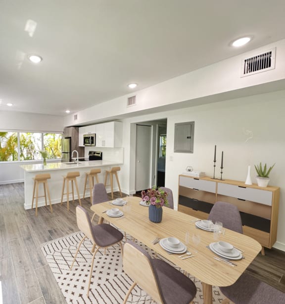 a dining room and kitchen with a table and chairs
