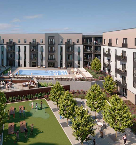 A large outdoor swimming pool surrounded by apartment buildings and a grassy area with people walking and sitting.
