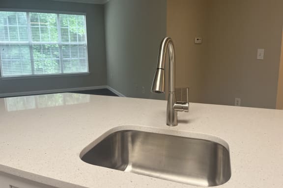 a kitchen with a sink and a window at The Berkeley, Duluth, GA, 30096