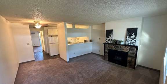 Clearwater Square Apartments in Kennewick, Washington Living Room with Fireplace and Kitchen