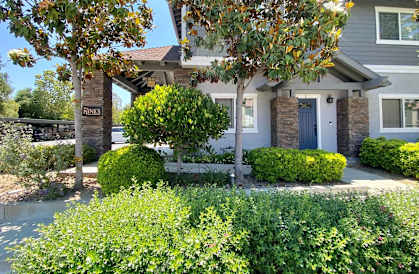 a house with a blue door and a bench in front of it