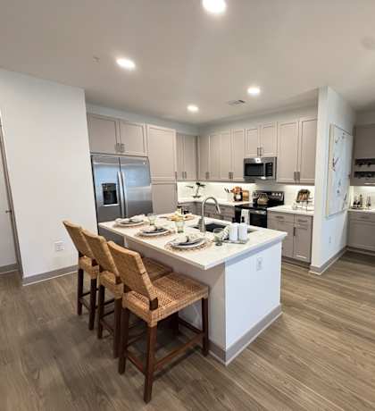 A modern kitchen with a dining table and chairs.