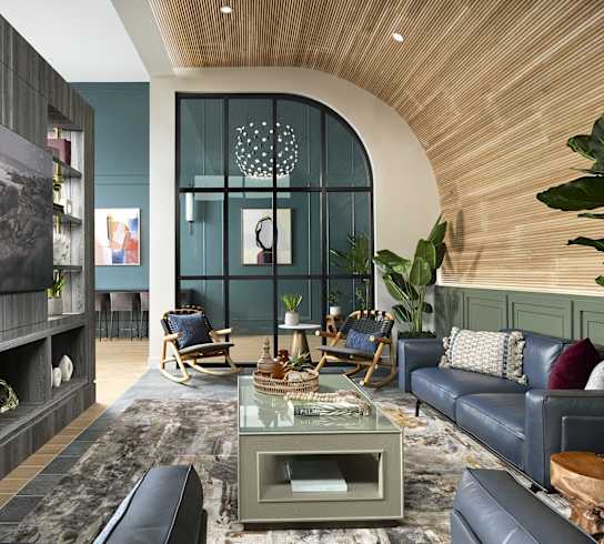 a living room with blue furniture and a large window