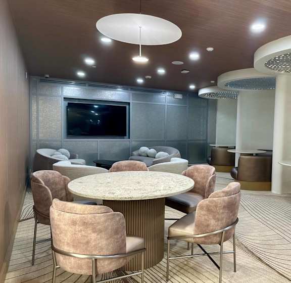 A modern dining room with a round table and chairs.