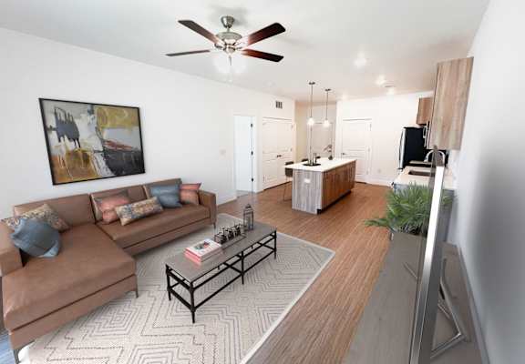 A living room with a brown couch and a coffee table.