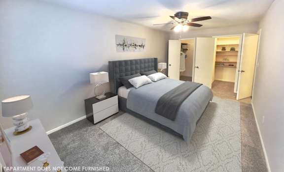 a bedroom with a bed and a ceiling fan