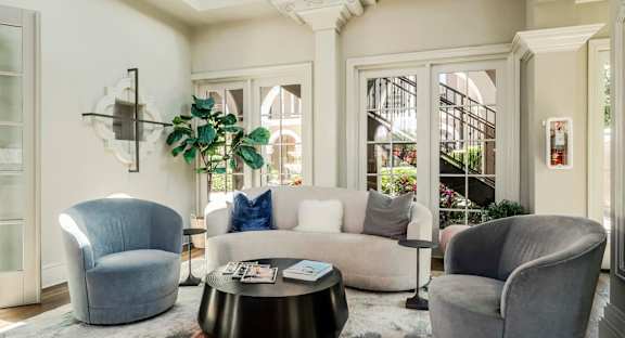 Modern clubhouse lounge with comfortable seating and natural light creating a welcoming atmosphere.