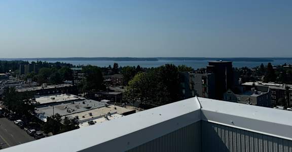 a view of the city and the lake from the roof of a building at Junction Central, Washington, 98116