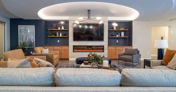 A modern living room with a fireplace and a television.