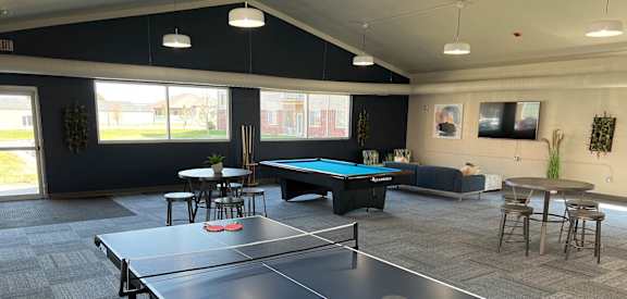 a games room with a ping pong table and a foosball table at at Courtyard Apartments on Belsly, Moorhead, Minnesota