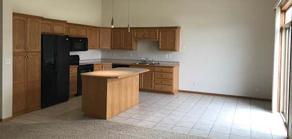 a kitchen with a center island and a stove top oven