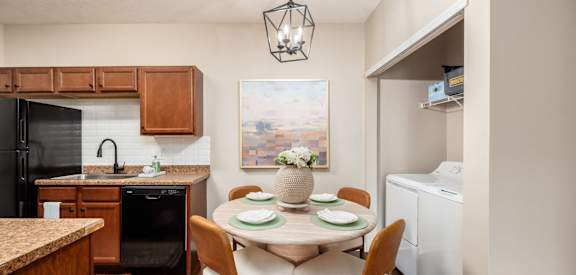 A kitchen with a dining table set for four.