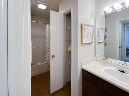 a bathroom with a sink and mirror in a 555 waverly unit