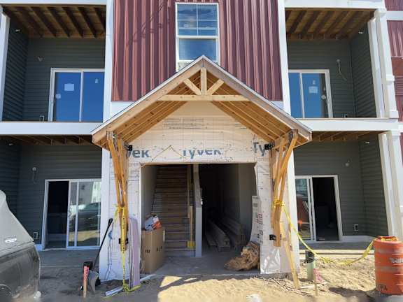A house under construction with a roof truss in place.