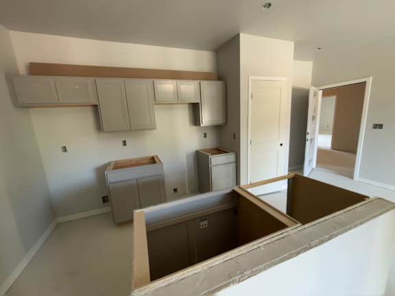 A kitchen with a countertop and cabinets is under construction.