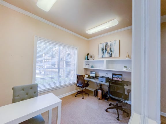 Community business center with computers and chairs.