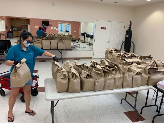 grocery bags being organized in the Lemon Hill community room