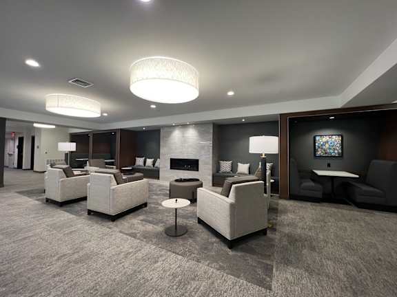 a living room with couches and chairs and a fireplace