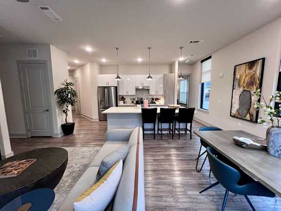 A modern kitchen with a dining table and chairs.