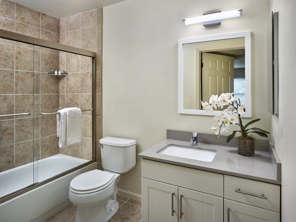 a bathroom with a toilet sink and shower and a mirror at AVE Malvern, Malvern, Pennsylvania