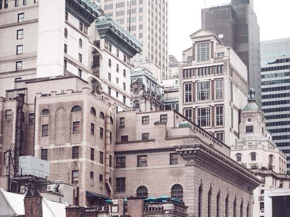 A cityscape with buildings of varying heights and architectural styles.