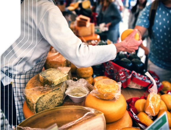 Man Handing Out Food at Farmers Market