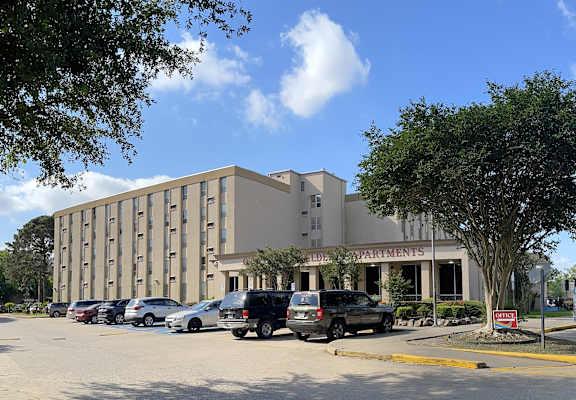 a large building with a parking lot in front of it