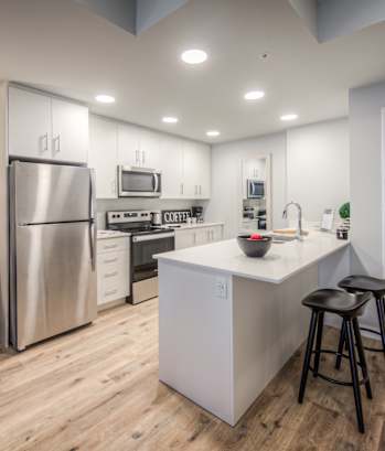 a kitchen with white cabinetry and stainless steel appliances