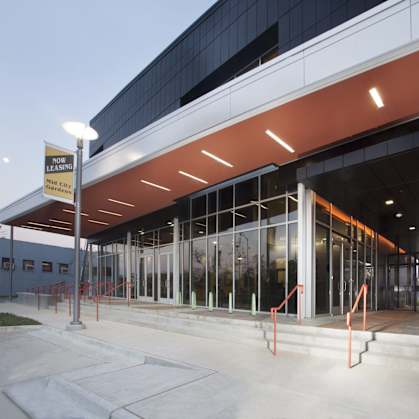 A building with a sign that says "Now Open" is shown.