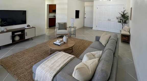 A living room with a grey couch and a coffee table.