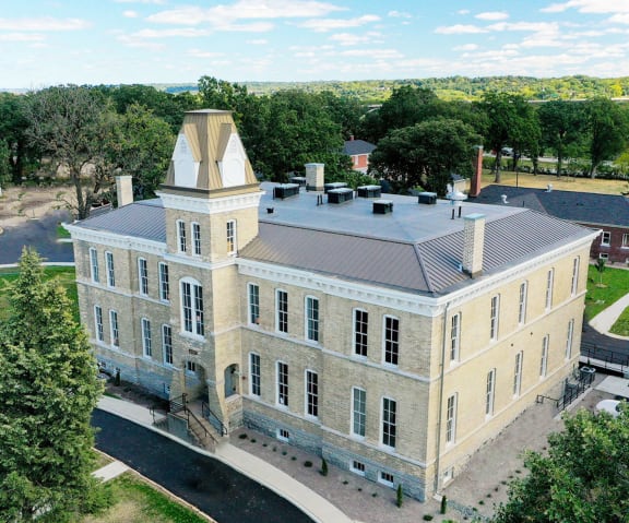 an aerial view of a brick building with a tower at Upper Post Flats, Minnesota