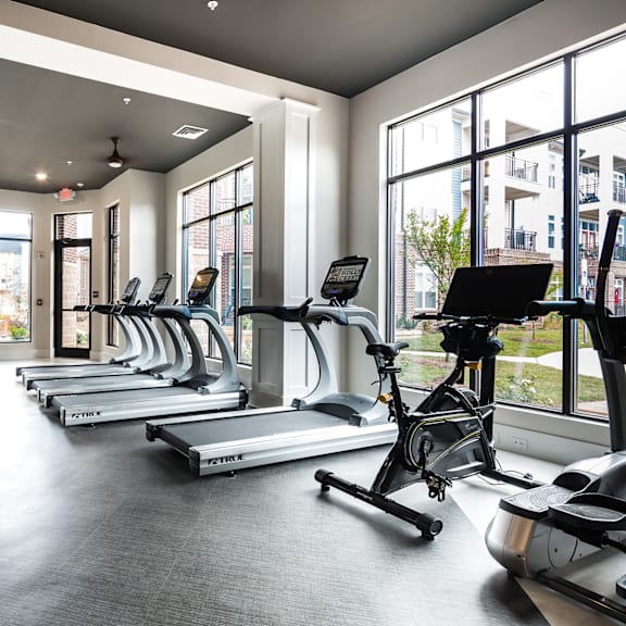 A gym with treadmills and exercise bikes.