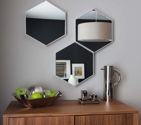 a table with a bowl of fruit and a lamp on it  at 888 Hilgard – Furnished Apartments, Los Angeles, CA