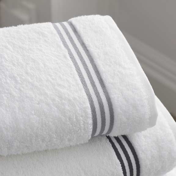 Two white towels with grey stripes on them.