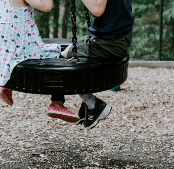Kids Swinging on Tire Swing