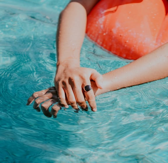 Woman in Swimming Pool with Pool Floaty