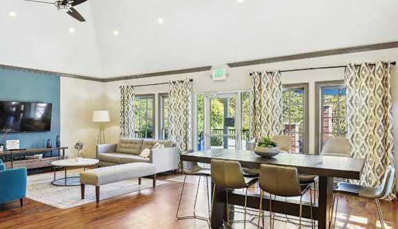 a living room and dining room with a table and chairs