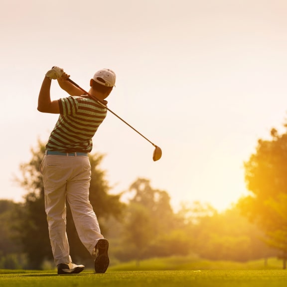 Man Golfing During Sunset